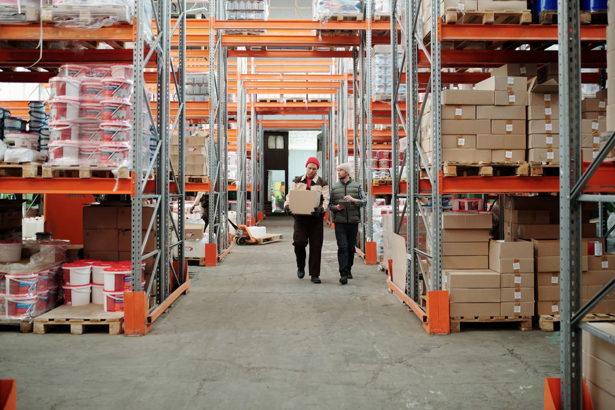 Colleagues walking through a warehouse aisle