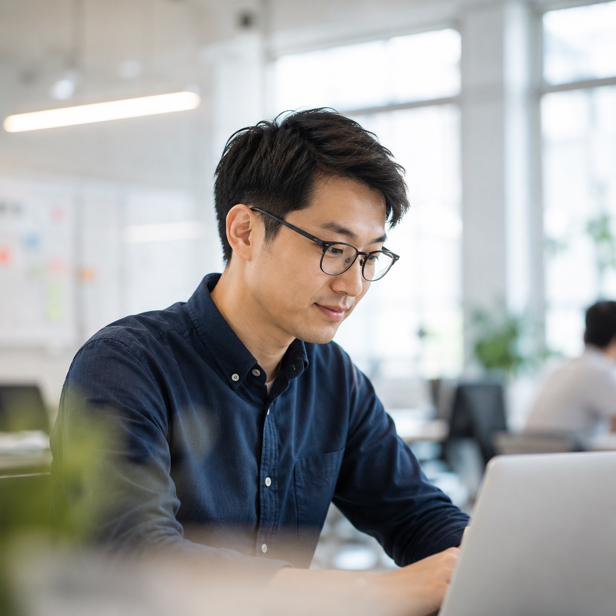An AI/ML specialist in deep focus at a warm-lit desk
